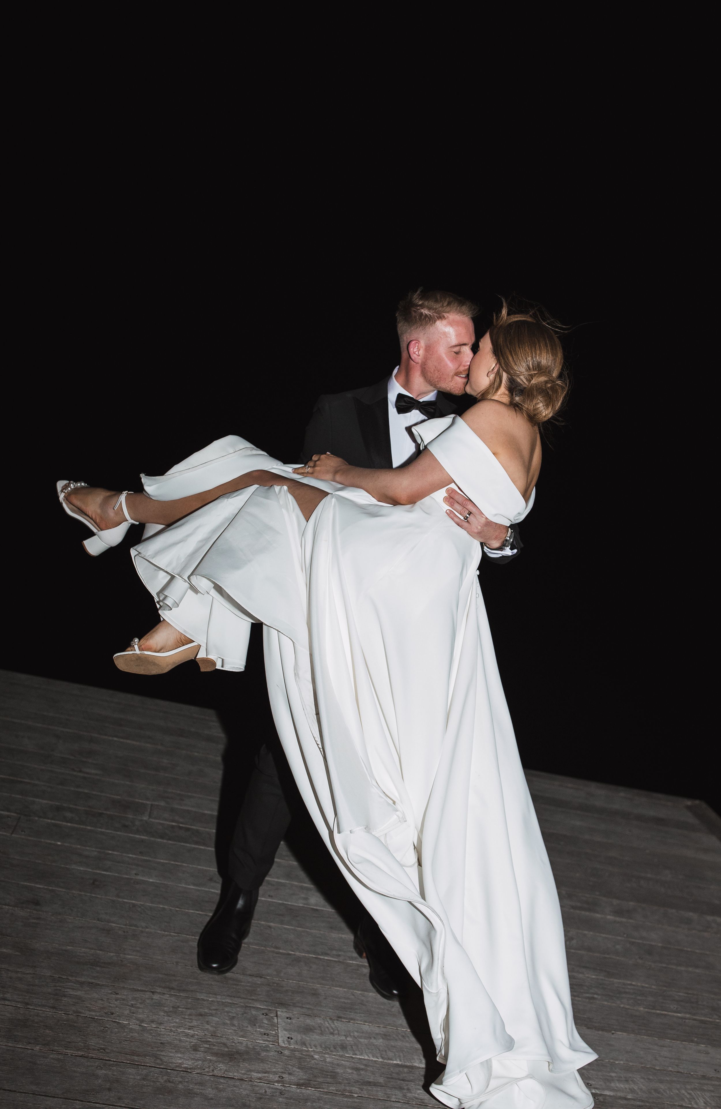 Romantic dance sequence showing couple in wedding attire spinning against dark background.