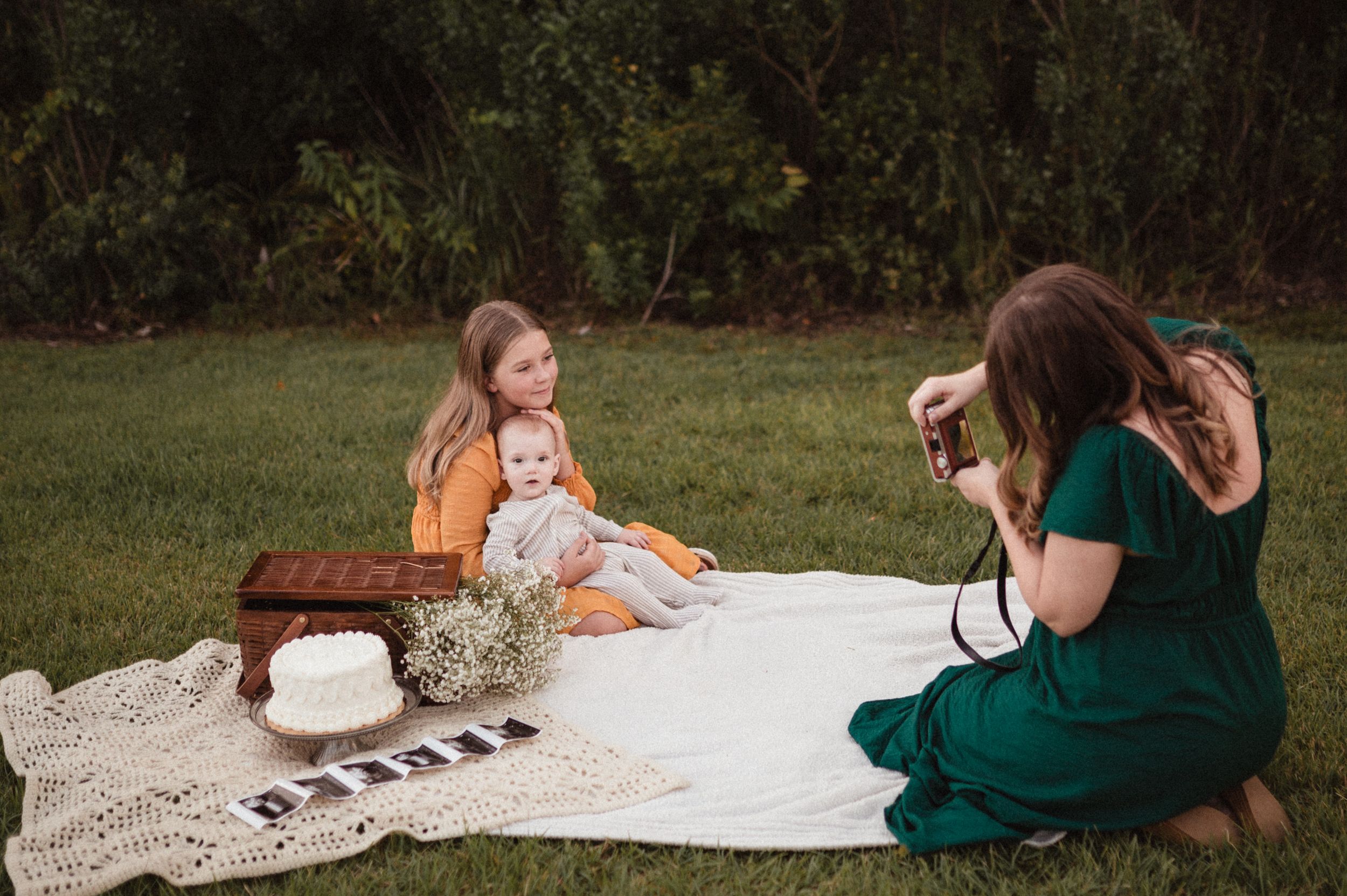 A sequence of outdoor photography sessions showing people sitting on white blankets in grassy settings.
