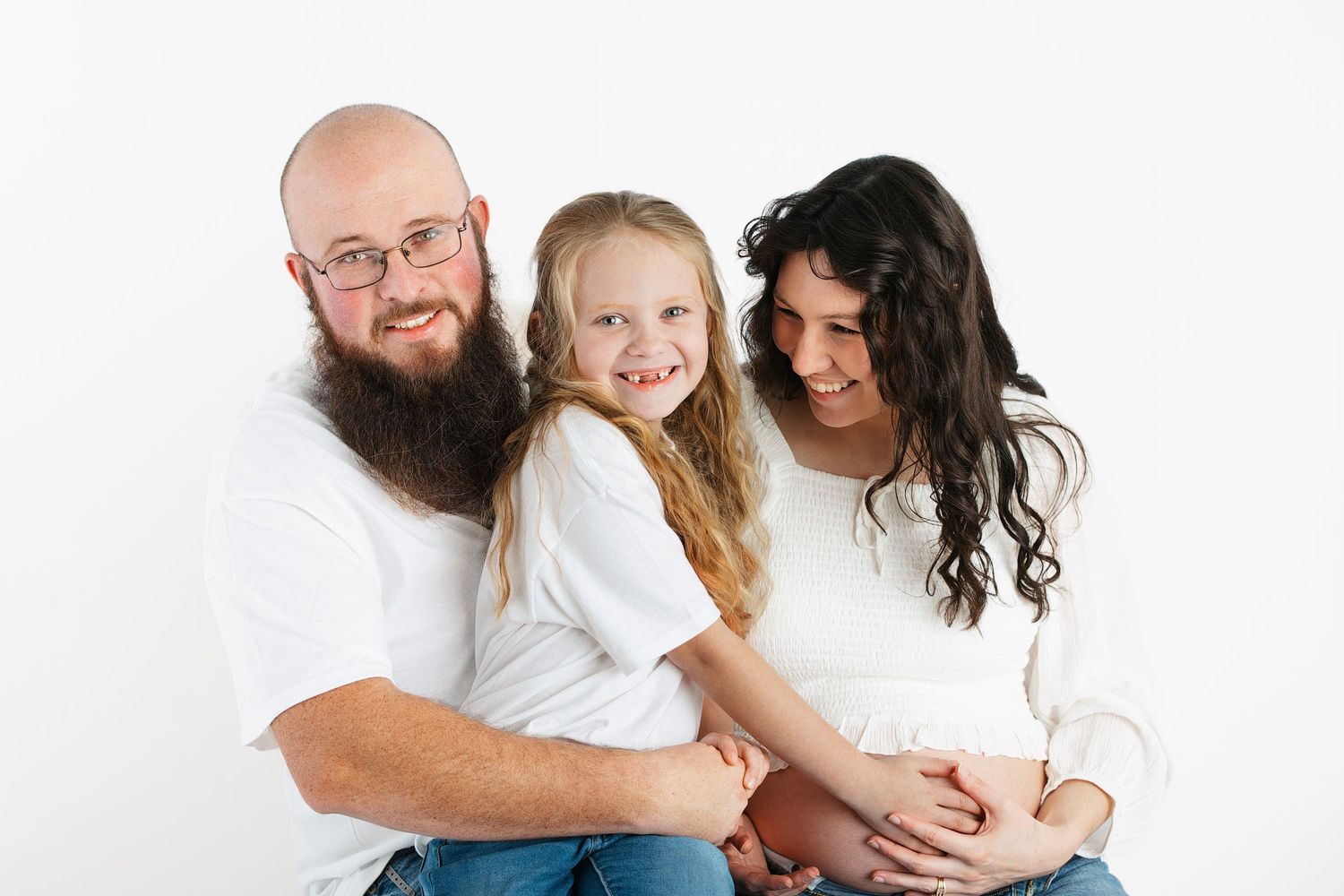 Studio maternity photoshoot of family in white.  Pregnancy photos.  30 week photos.  Maternity photographer.