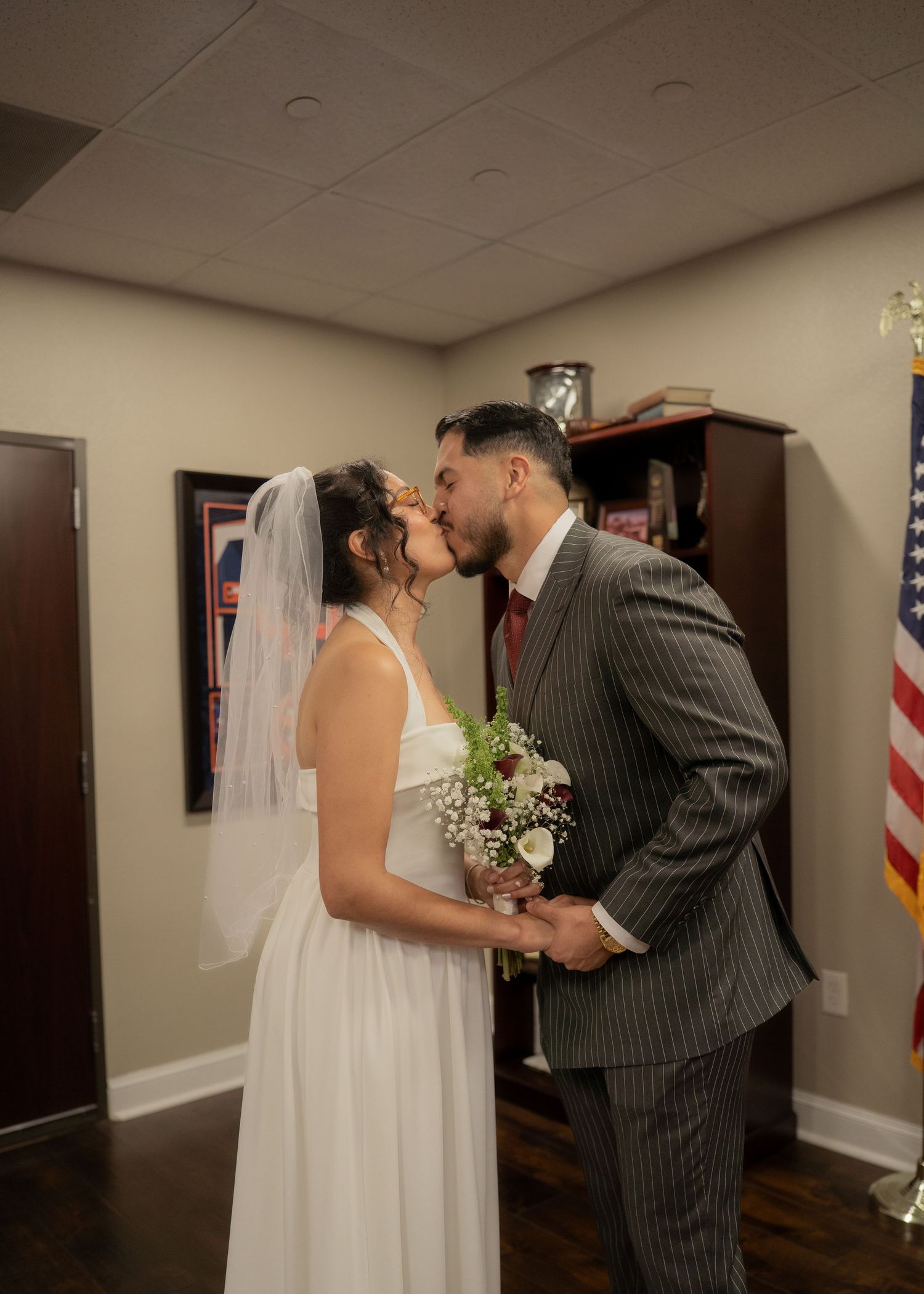 Rubi and Joe Yerena exchanging vows in a small, intimate courthouse ceremony in Houston, guided by a friendly judge.