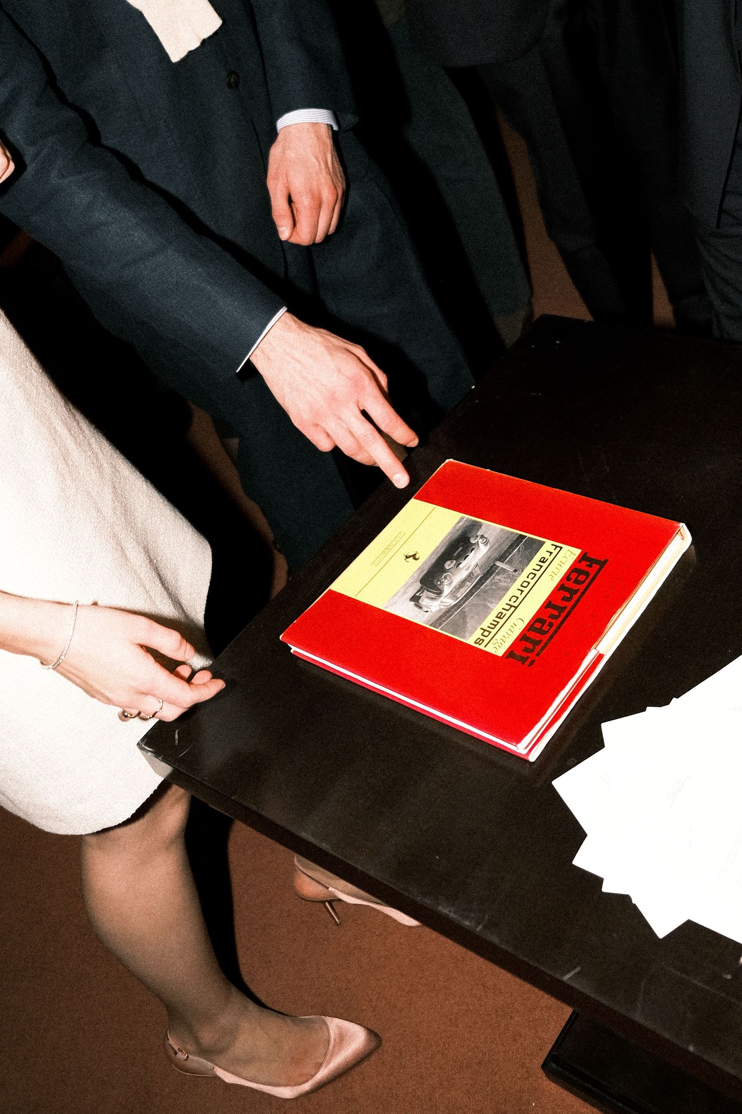 A series of hands reaching out against a white curtain background in a creative artistic composition.