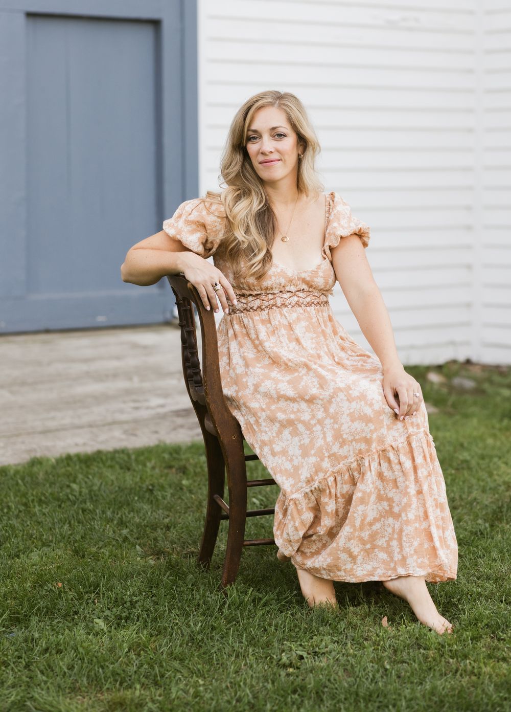 A mother sits on an antique chair for portrait during the Forget Me Not Photography Business Mentorship at Saltonstall Farm in Stratham, NH.