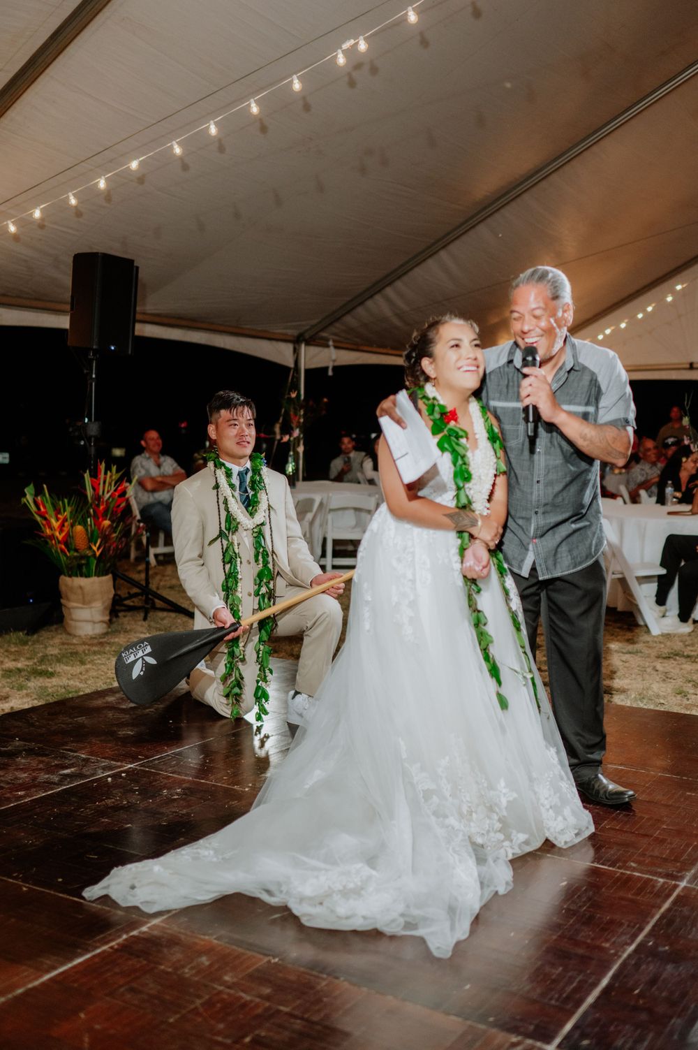 A wedding celebration features coordinated dance moves on a wooden dance floor.
