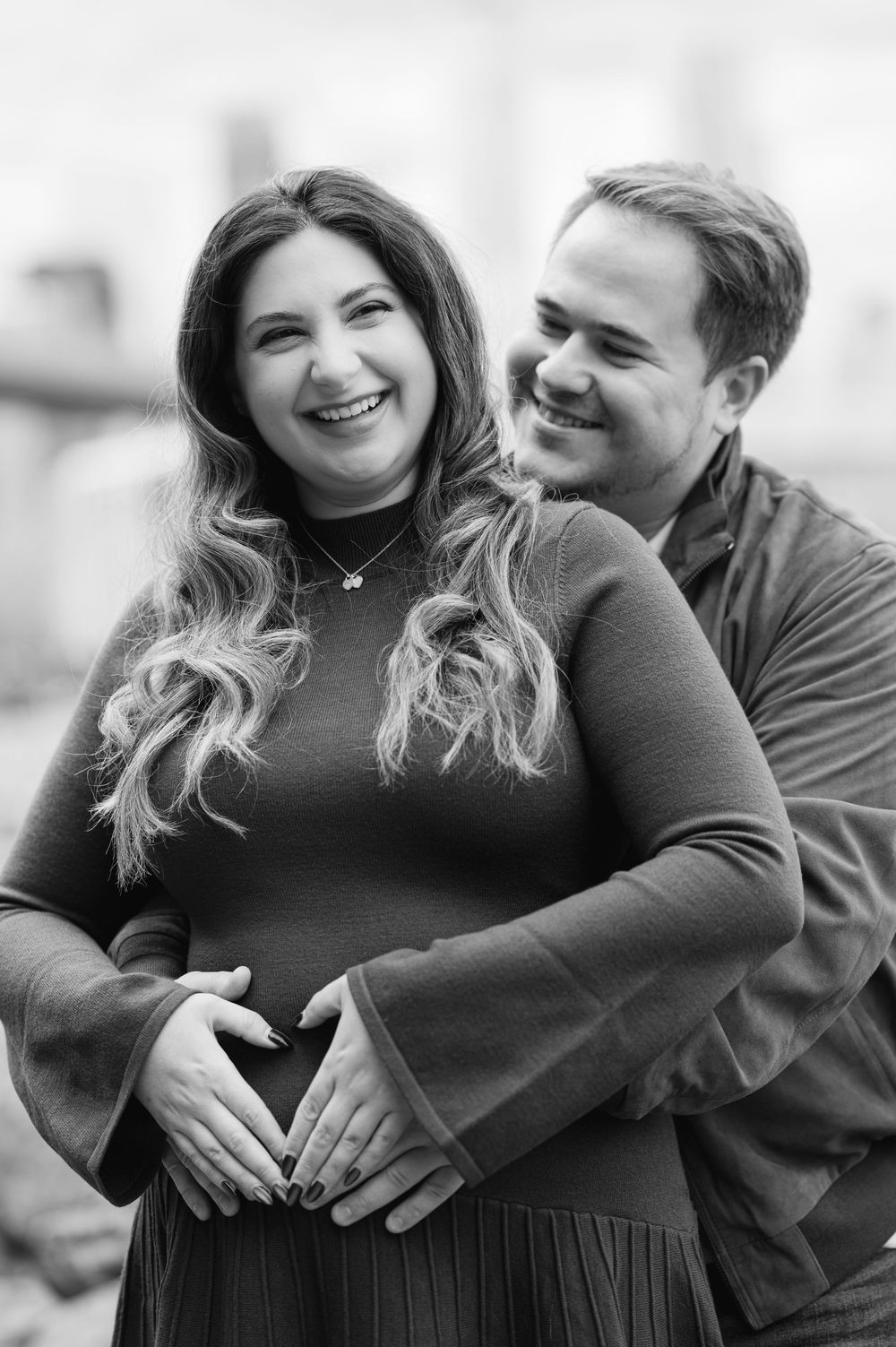 A black and white photo series showing a couple sharing intimate laughs and embraces.