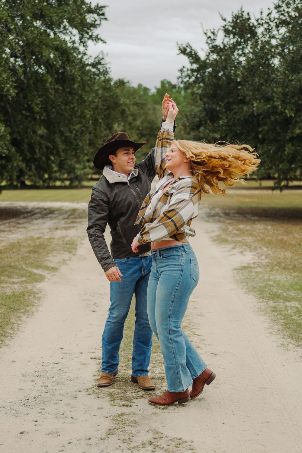 A playful sequence of dance moves on a dirt path surrounded by green trees.