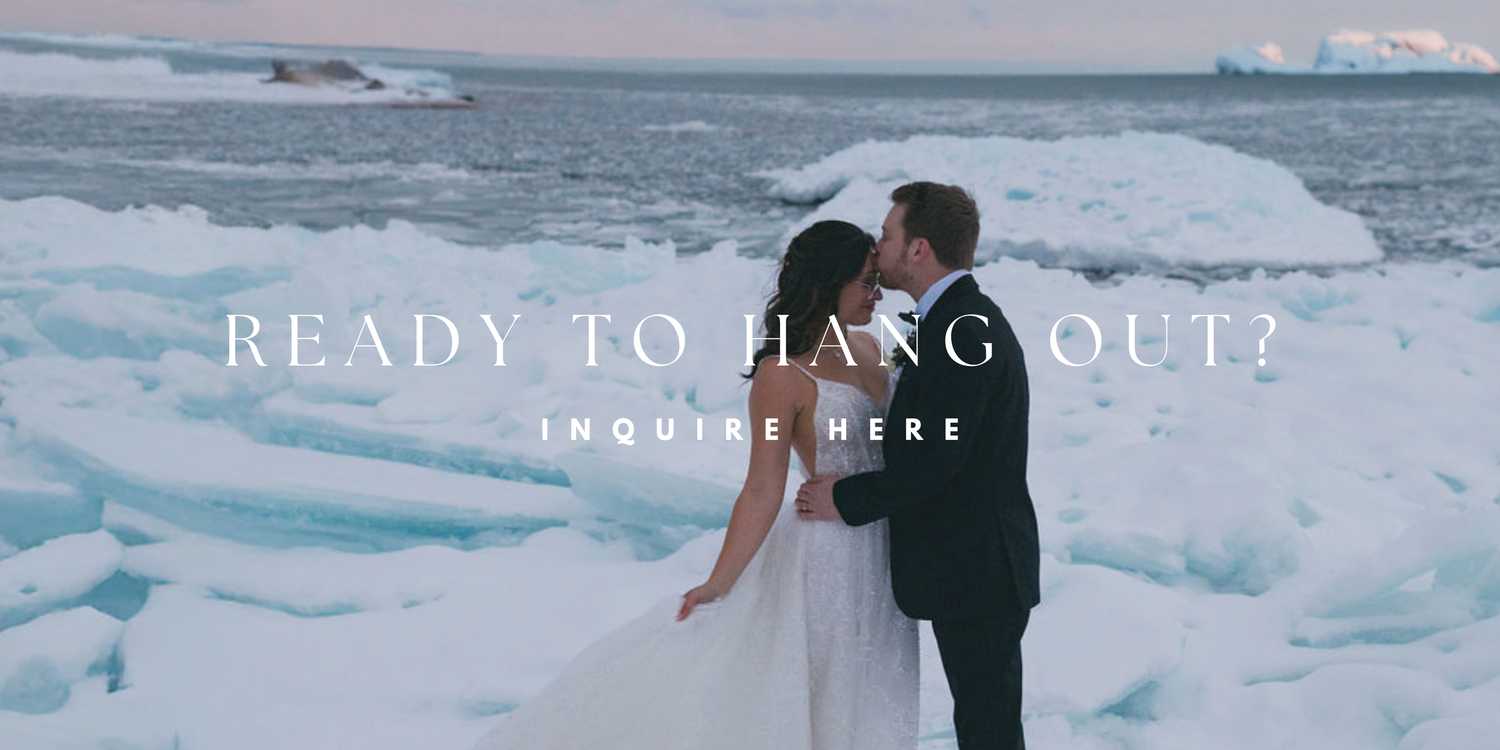 A couple shares a romantic moment on a frozen landscape of ice and snow during a winter wedding photoshoot.
