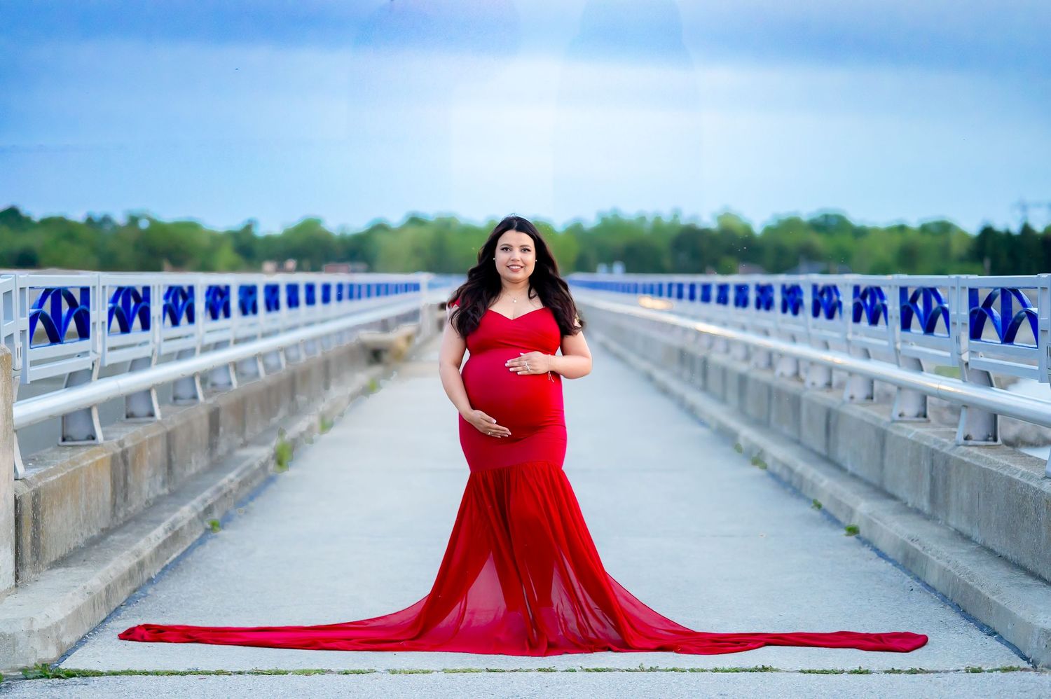 A flowing purple maternity gown billows dramatically against a gray backdrop in a series of elegant poses.