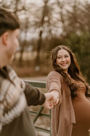 Candid moments between couple during outdoor photo session.