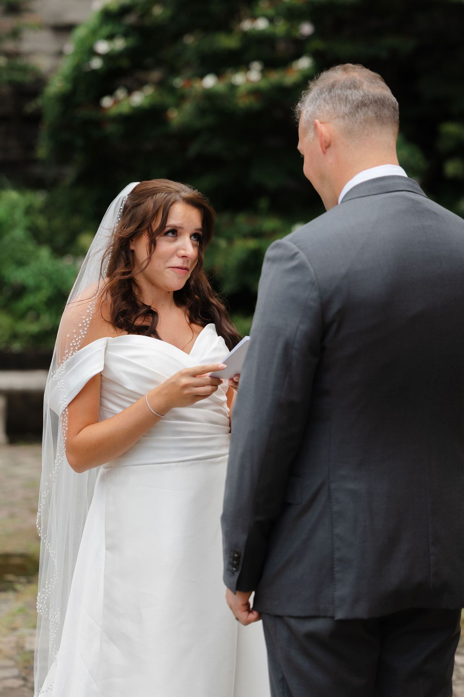 Bride and groom exchanging vows at Italian Cultural Gardens in Cleveland, Ohio.