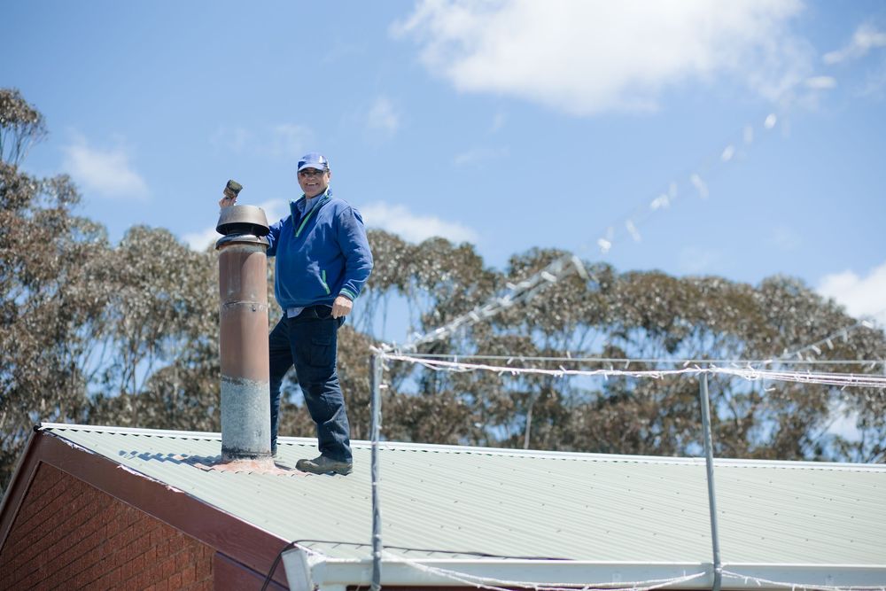 A family member on a roof at a wedding in preparation for the ceremony