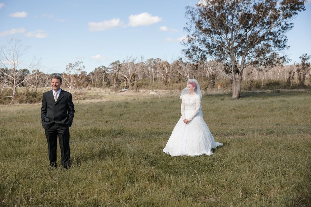 Bride sharing a quiet moment with her father in a country home before a private property wedding ceremony. Dad reveal