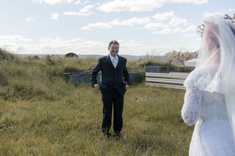 Bride sharing a quiet moment with her father in a country home before a private property wedding ceremony