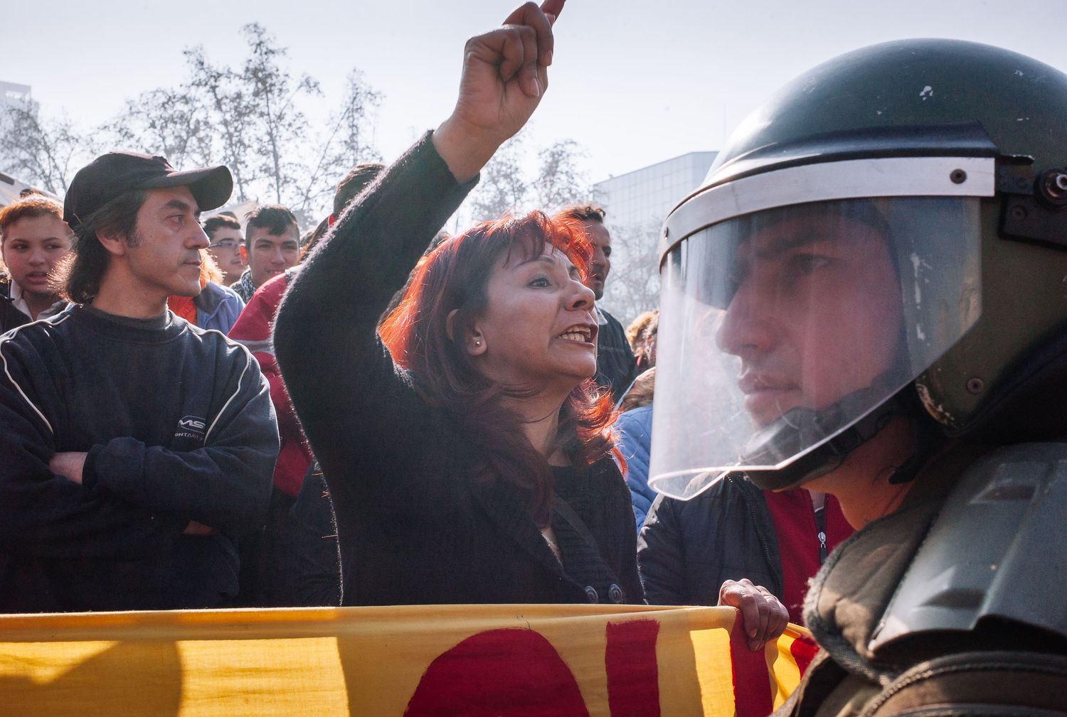 Interaction between protesters and riot police during a street demonstration for a fairer education system. Santiago, Chile