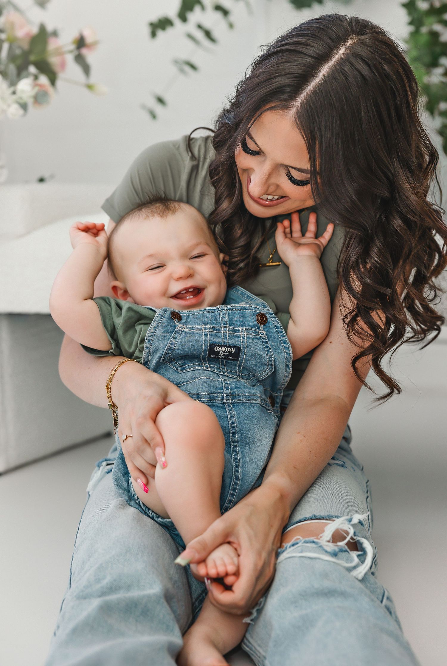 Playful indoor photoshoot with denim and casual attire against a white background.