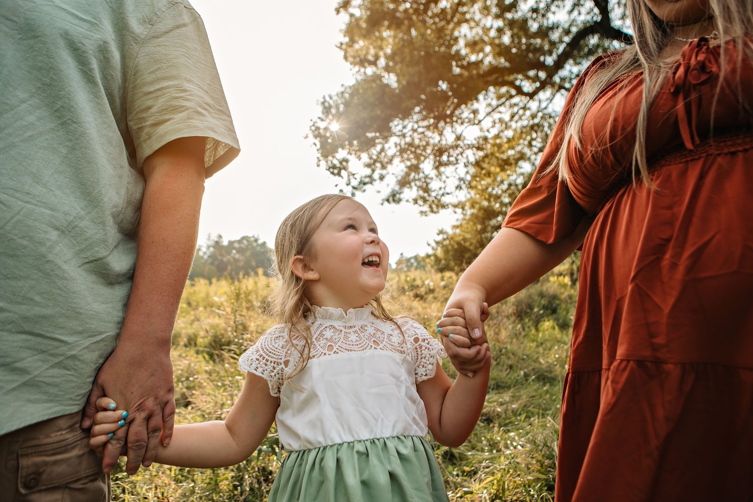 Candid family moments captured in natural lighting outdoors.