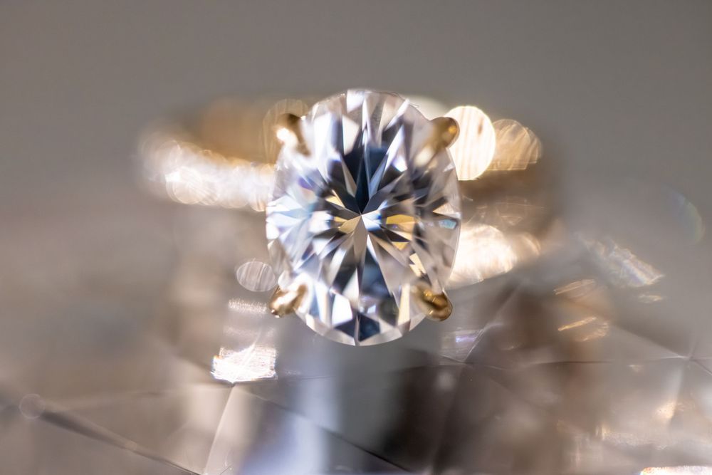 A sparkling diamond solitaire ring shown in a close-up macro photography sequence with varying focus and lighting effects.