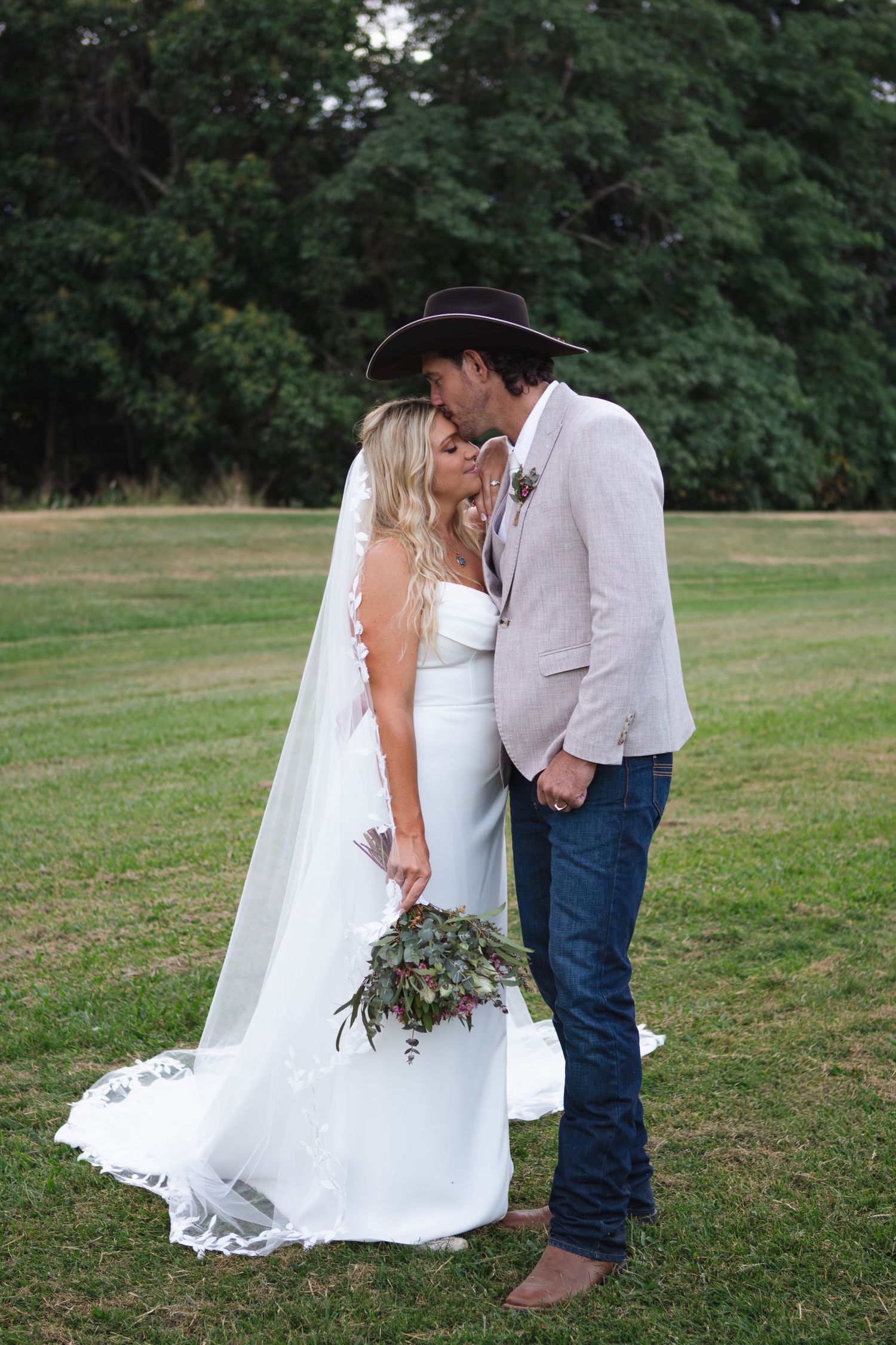 Groom kissing bride on forehead at country Port Douglas Wedding