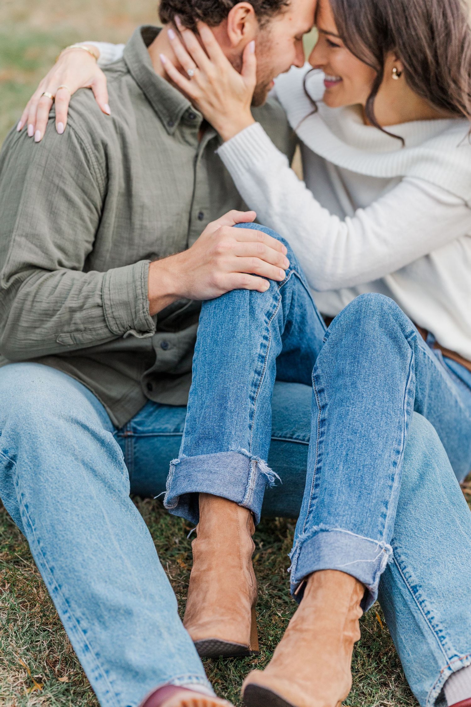 A couple in casual clothing sitting on grass showing intimate moments in a series of romantic photos.