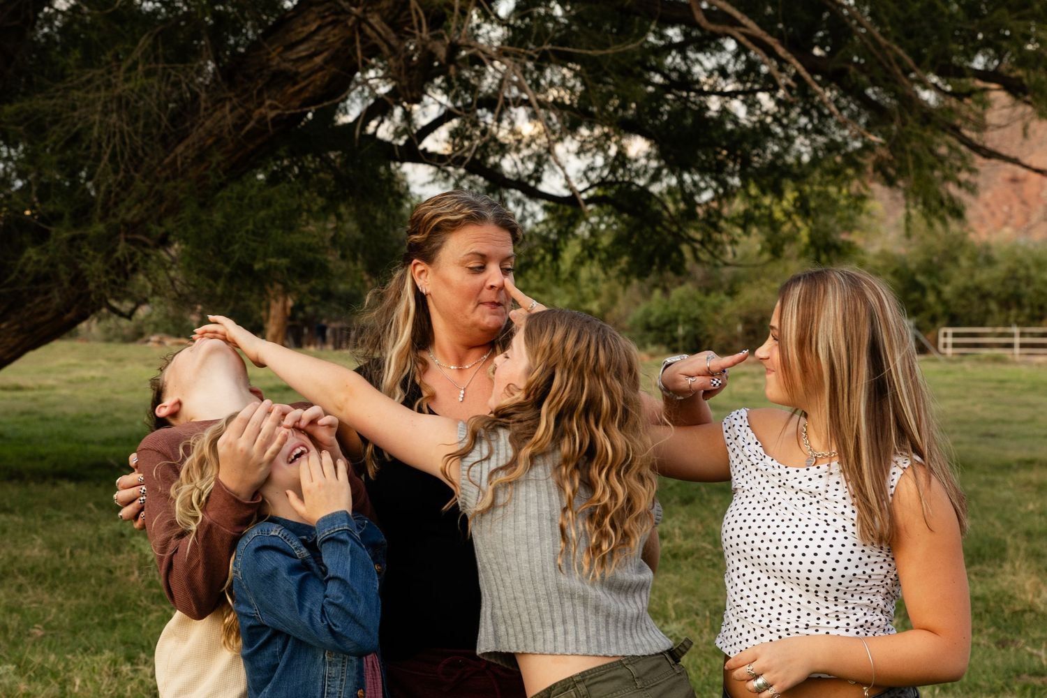 playful family photos St. George utah mom with 4 kids all being silly touching each other's noses