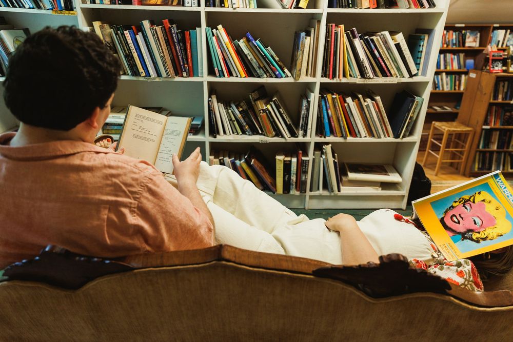 A library interior with multiple bookshelves filled with colorful books.