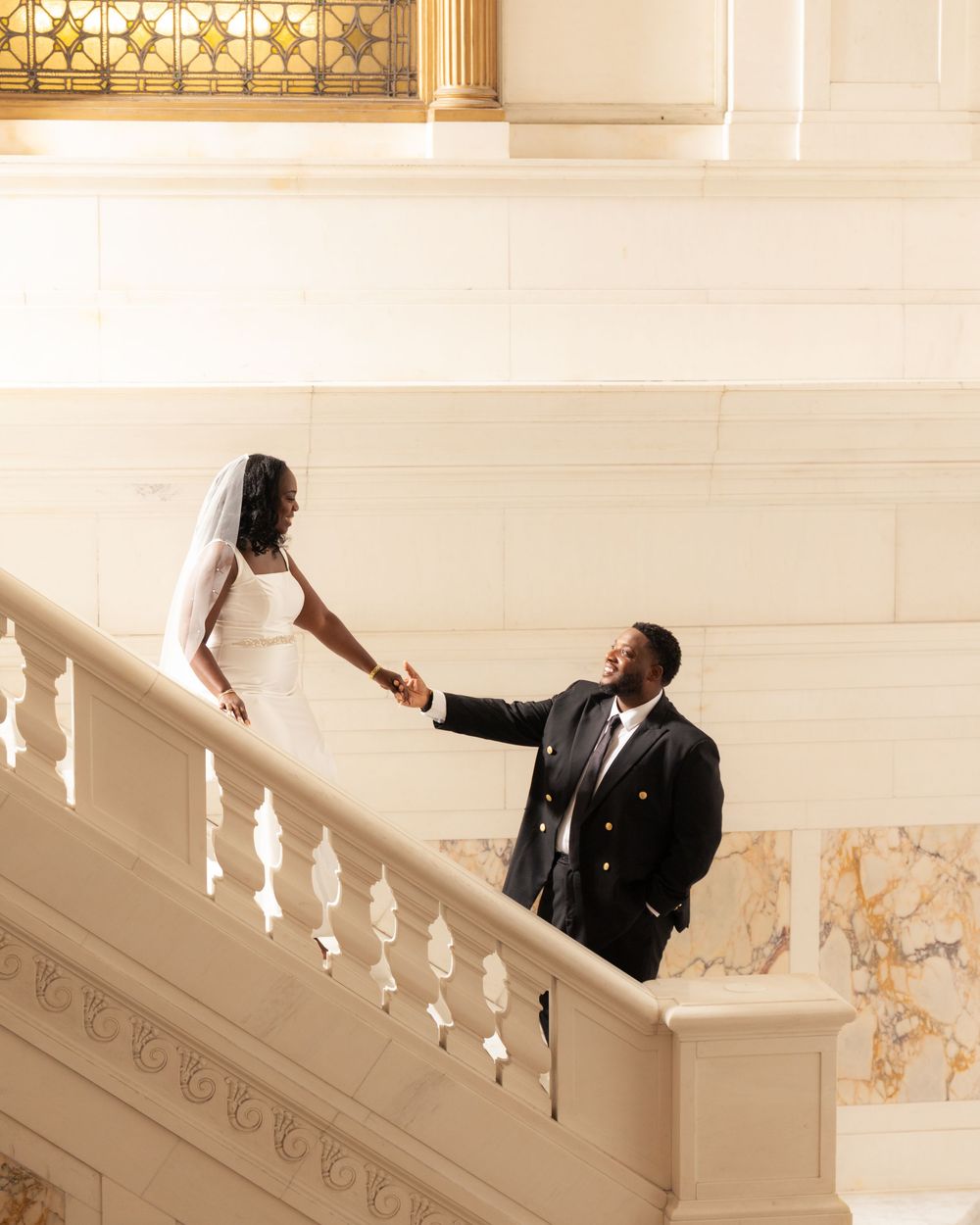 Wedding photography sequence captured on an elegant white staircase at the Kimpton Hotel in Baltimore City