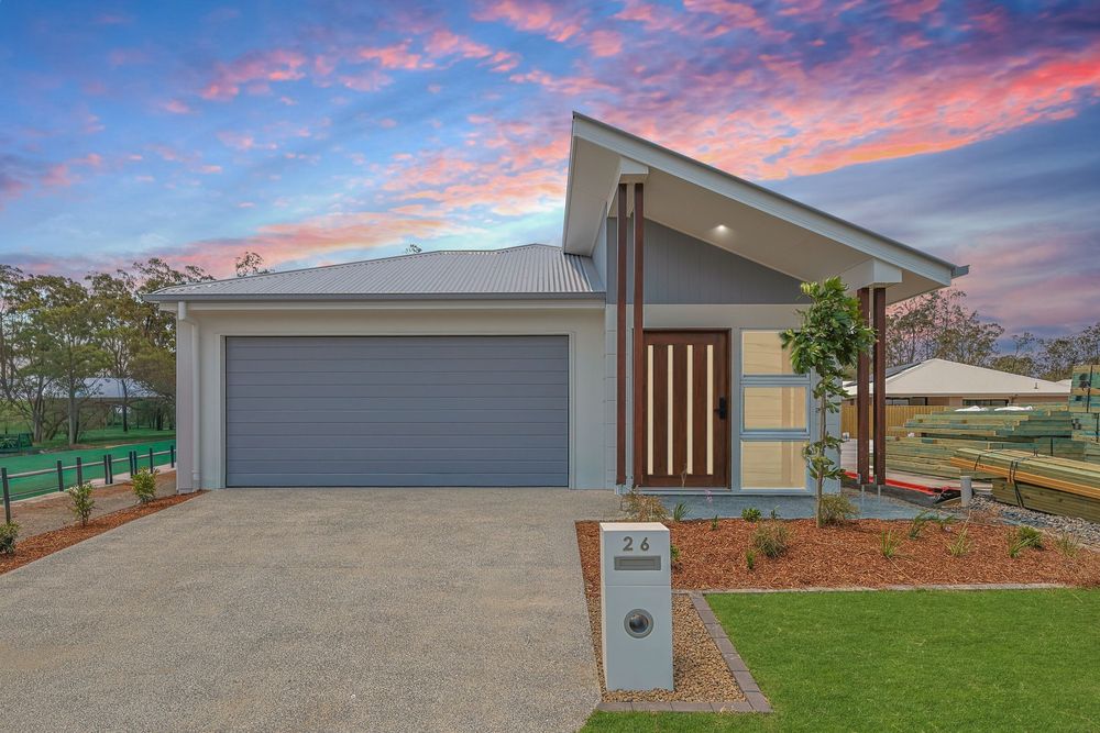 Twilight exterior photo of a modern family home, highlighting clean design and curb appeal for real estate advertising.