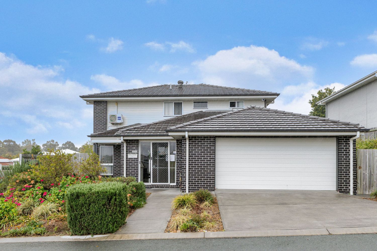 Real estate photo of a modern two-storey brick home with double garage, photographed for property listings in Gold Coast and Brisbane.