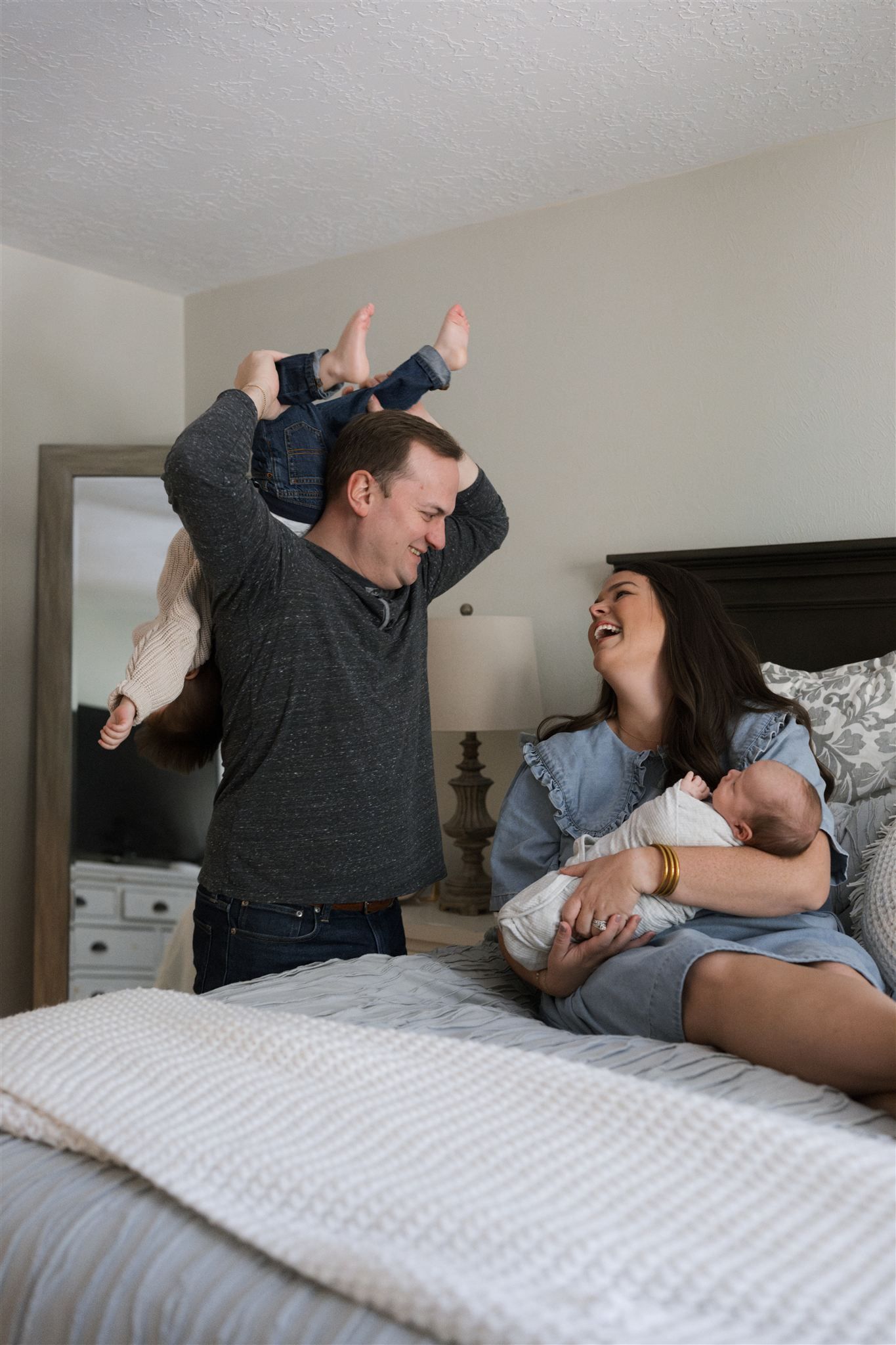 A playful moment during an in home family photo session in The Woodlands Tx