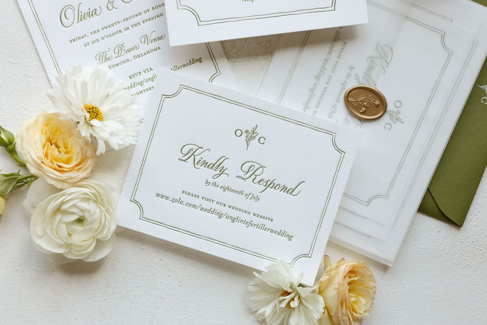 Elegant wedding invitation suite with yellow roses and white flowers on a light background with green accents.