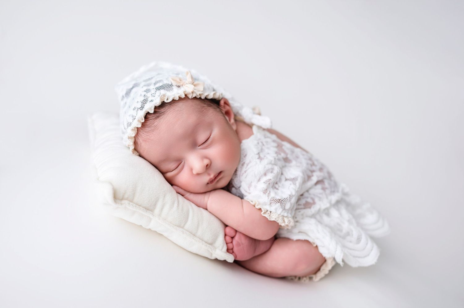 Newborn baby peacefully sleeping during studio photo session