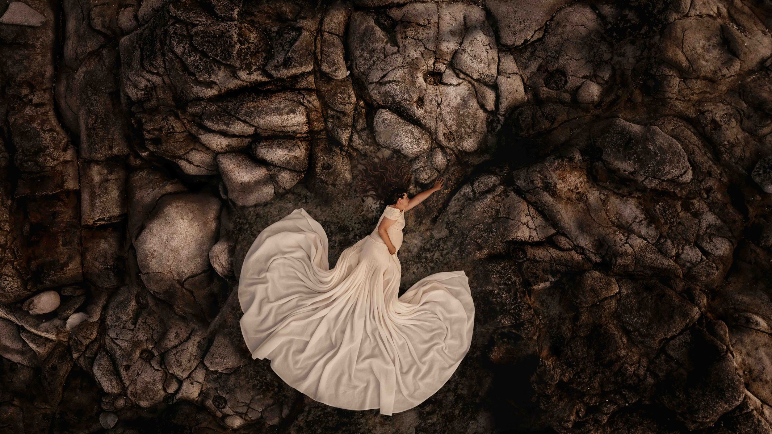 Aerial Maternity Photo. Jervis Bay. Nature Textures. pregnant women laying on rocks, submerged in the textures of Jervis Bay