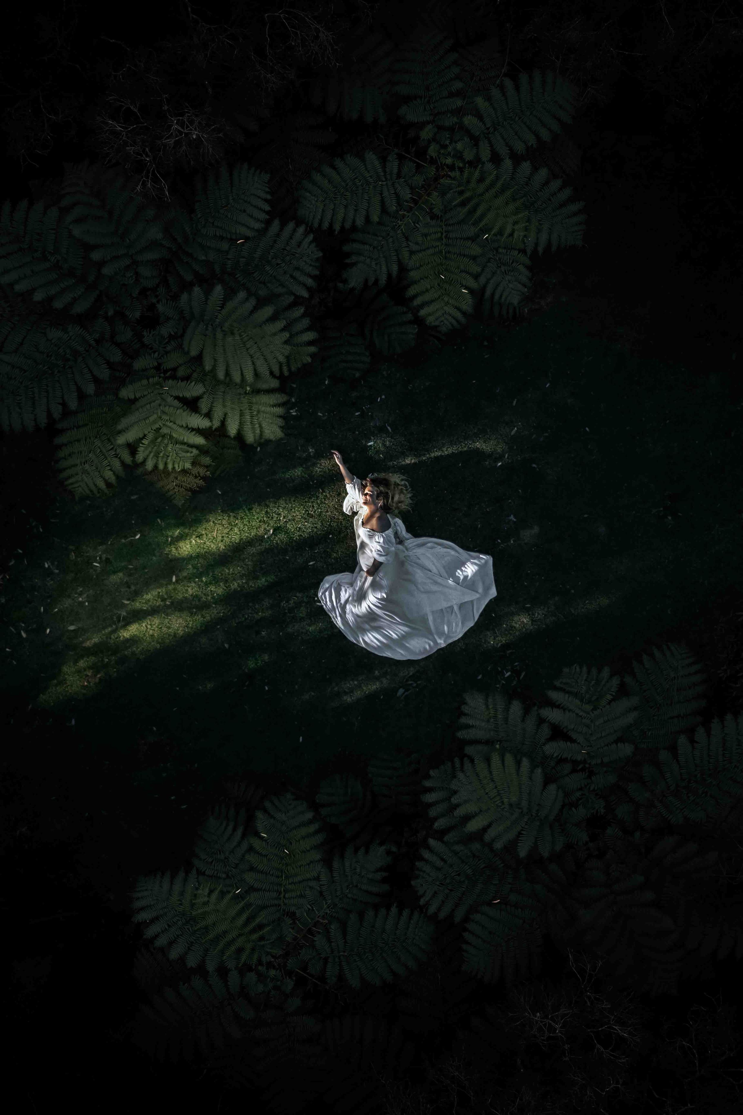 Aerial Maternity Cave Beach Jervis Bay. Pregnant women laying in the rich greenery of the Jervis Bay National Park.