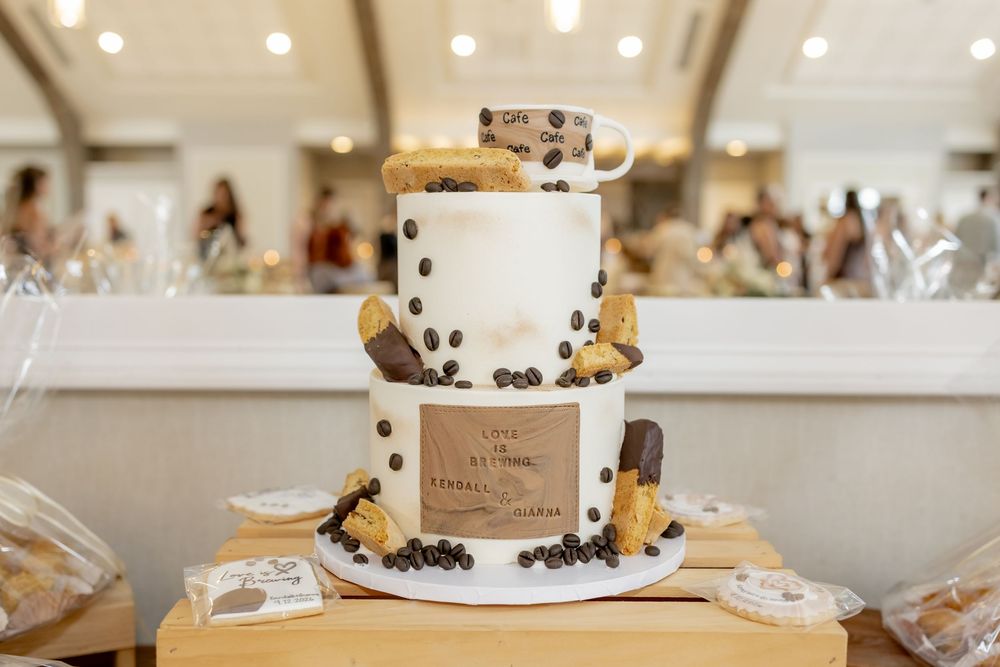 A two-tier biscotti and coffee themed cake at a bridal shower.