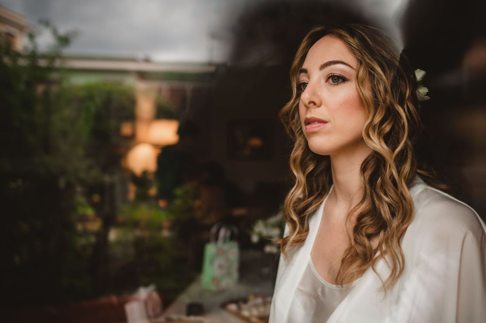 Getting ready photos with soft lighting and elegant makeup application.