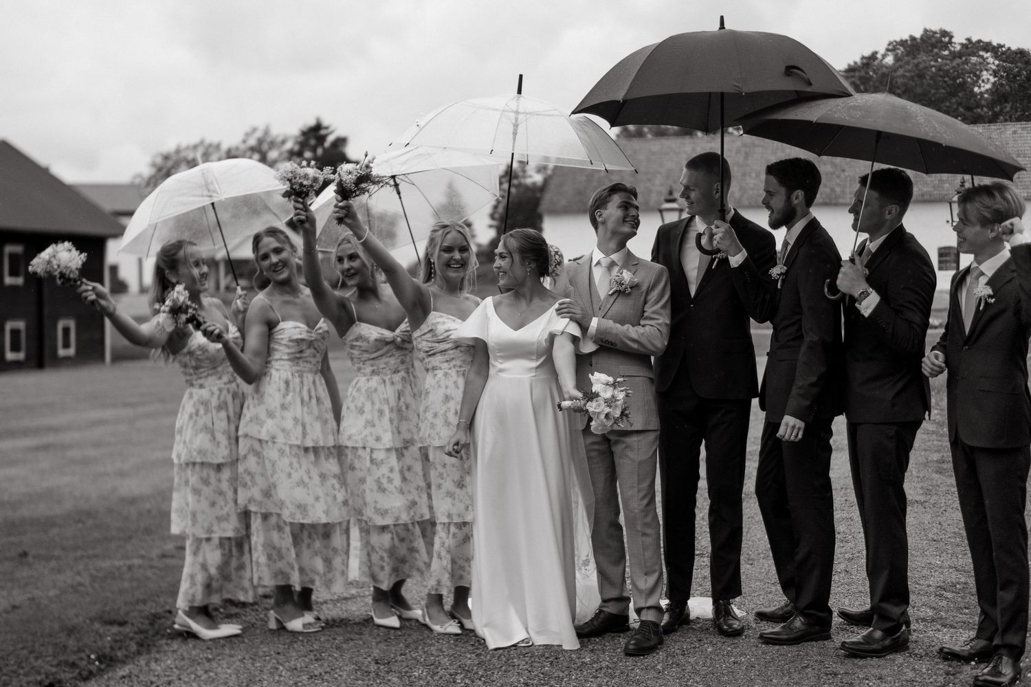 bride and groom posing for wedding portraits with bridesmaids and groomsmen during naturally looking wedding photography shoot in Stockholm