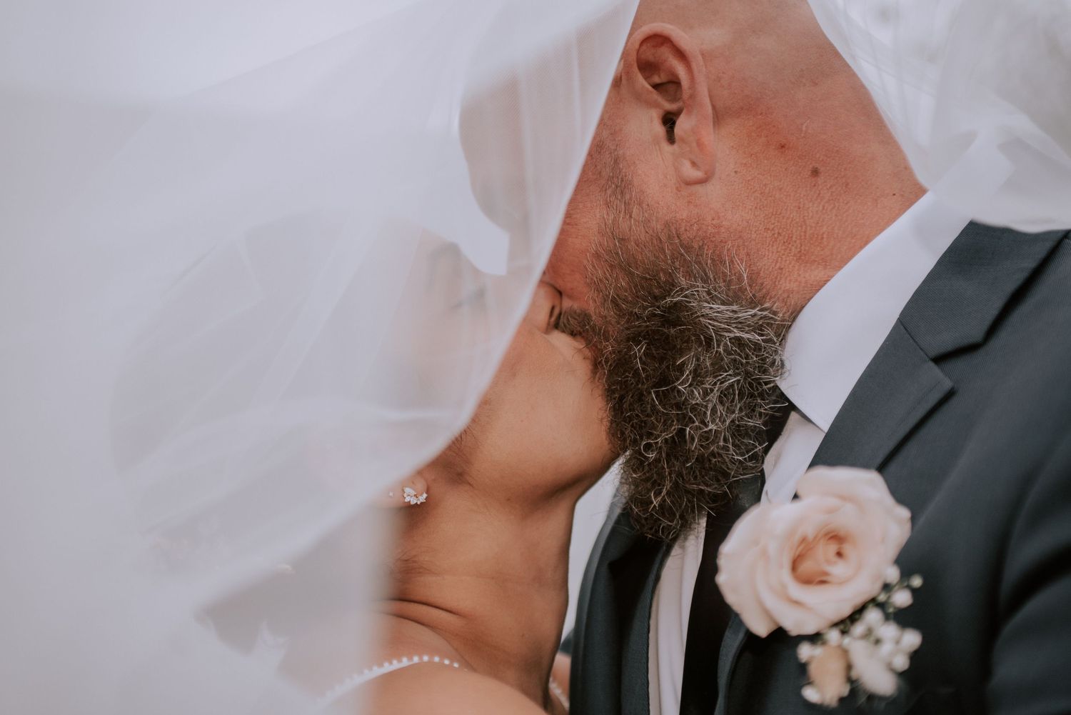 Bride and Groom under veil at backyard wedding in San Diego CA