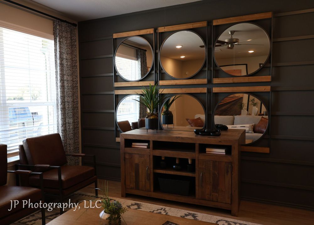 Modern living room decor featuring geometric mirror wall display and wooden media console.