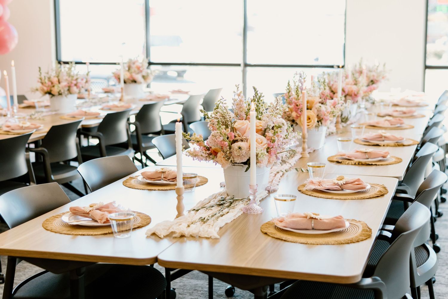 Elegant table setting with gold chargers and blush pink decor for a special occasion.