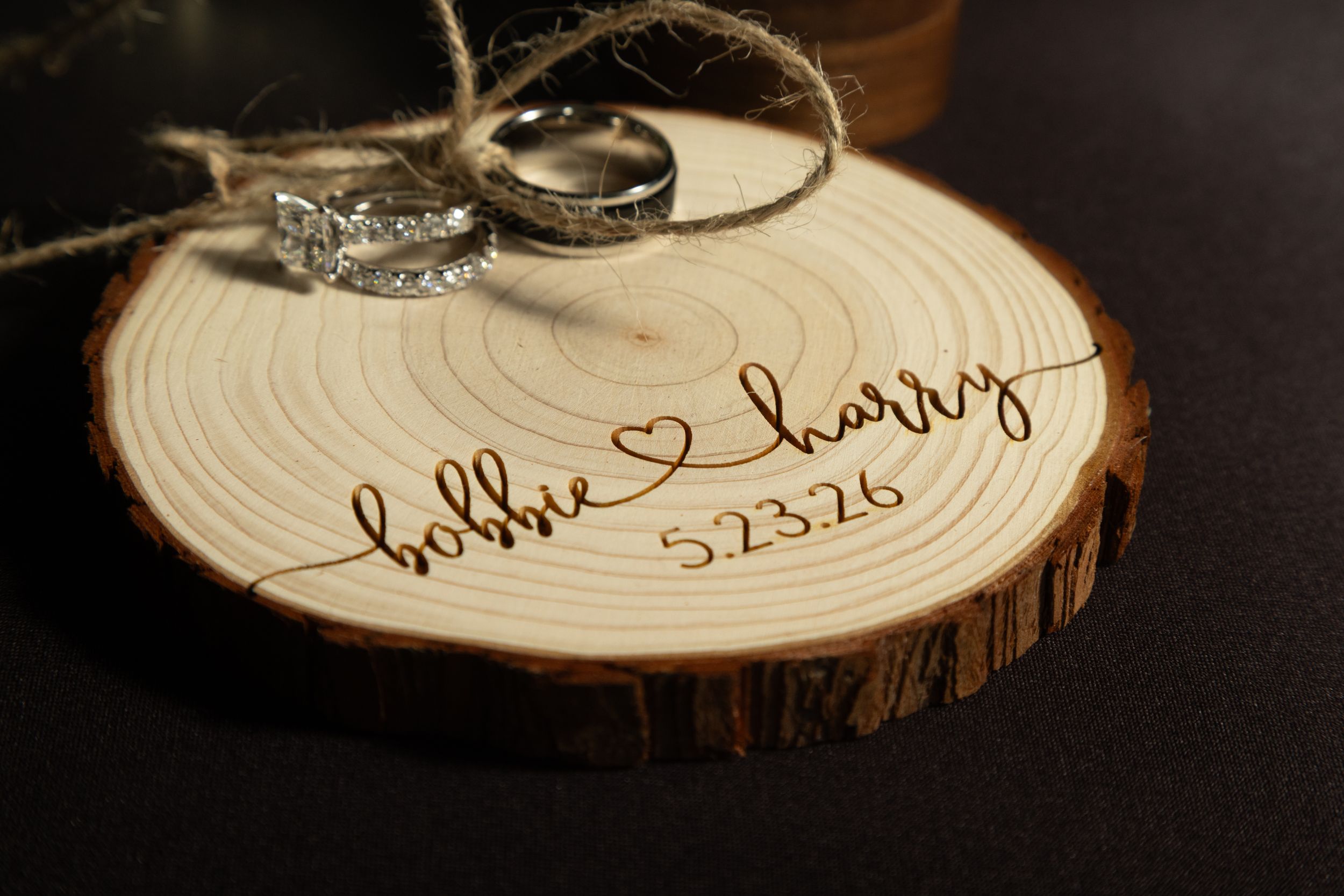 Personalized wooden ring bearer slice engraved with names bobbie and harry and wedding date 5.23.26.