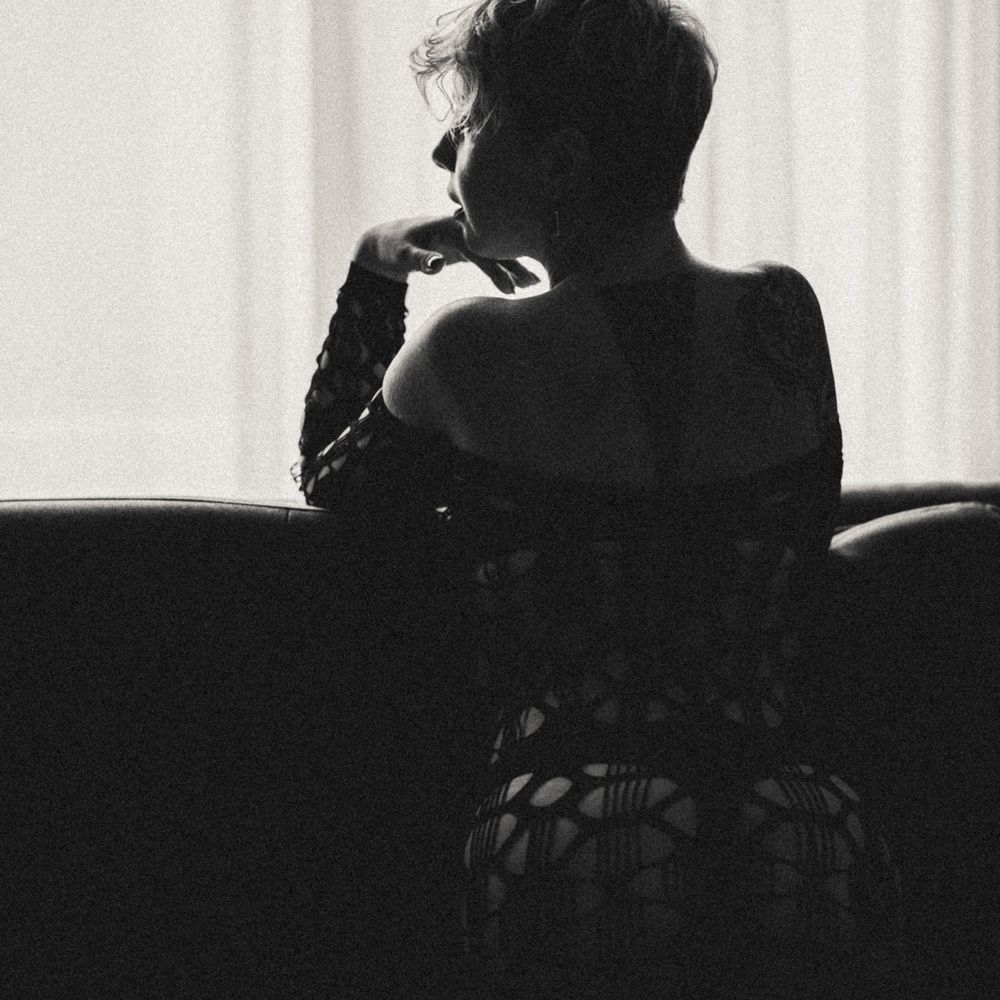 Artistic black and white silhouettes of a couple in intimate poses against a light background.