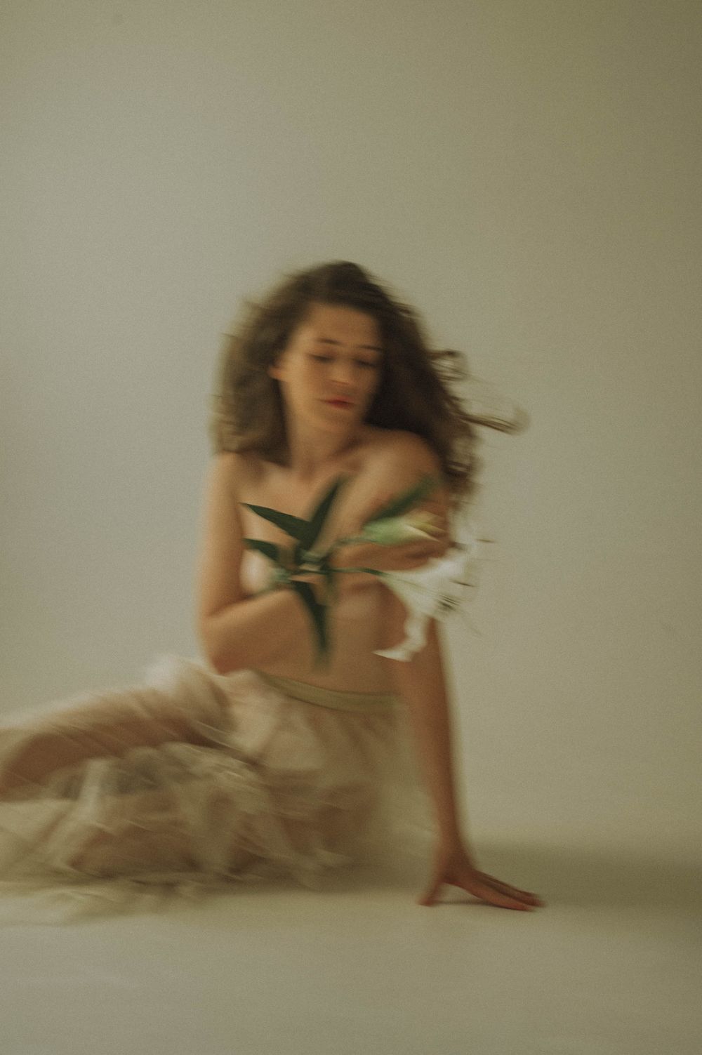 Motion blur portrait in ethereal setting with flowing fabric.