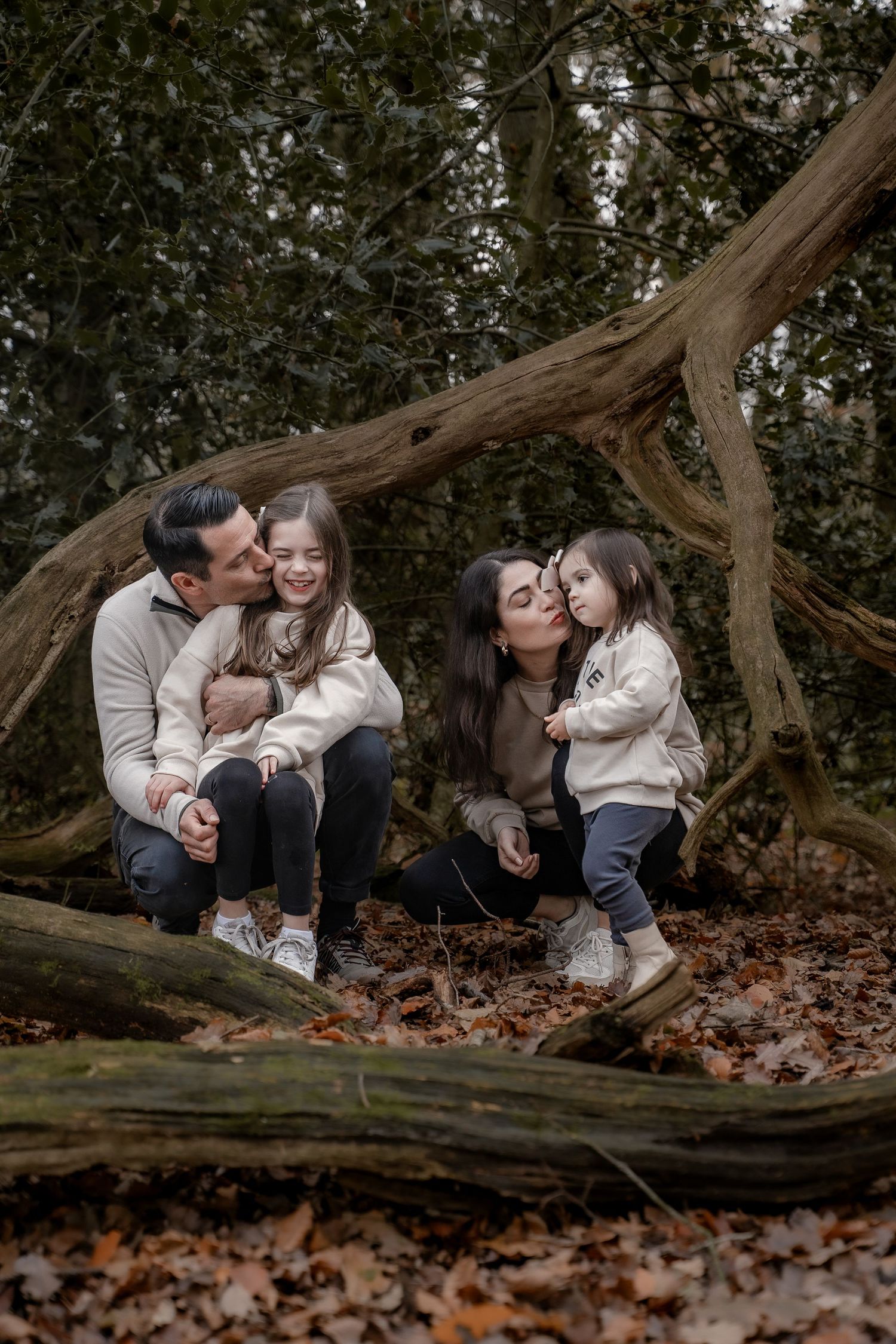 Lifestyle photoshoot in Derbyshire capturing authentic family moments among fallen leaves.