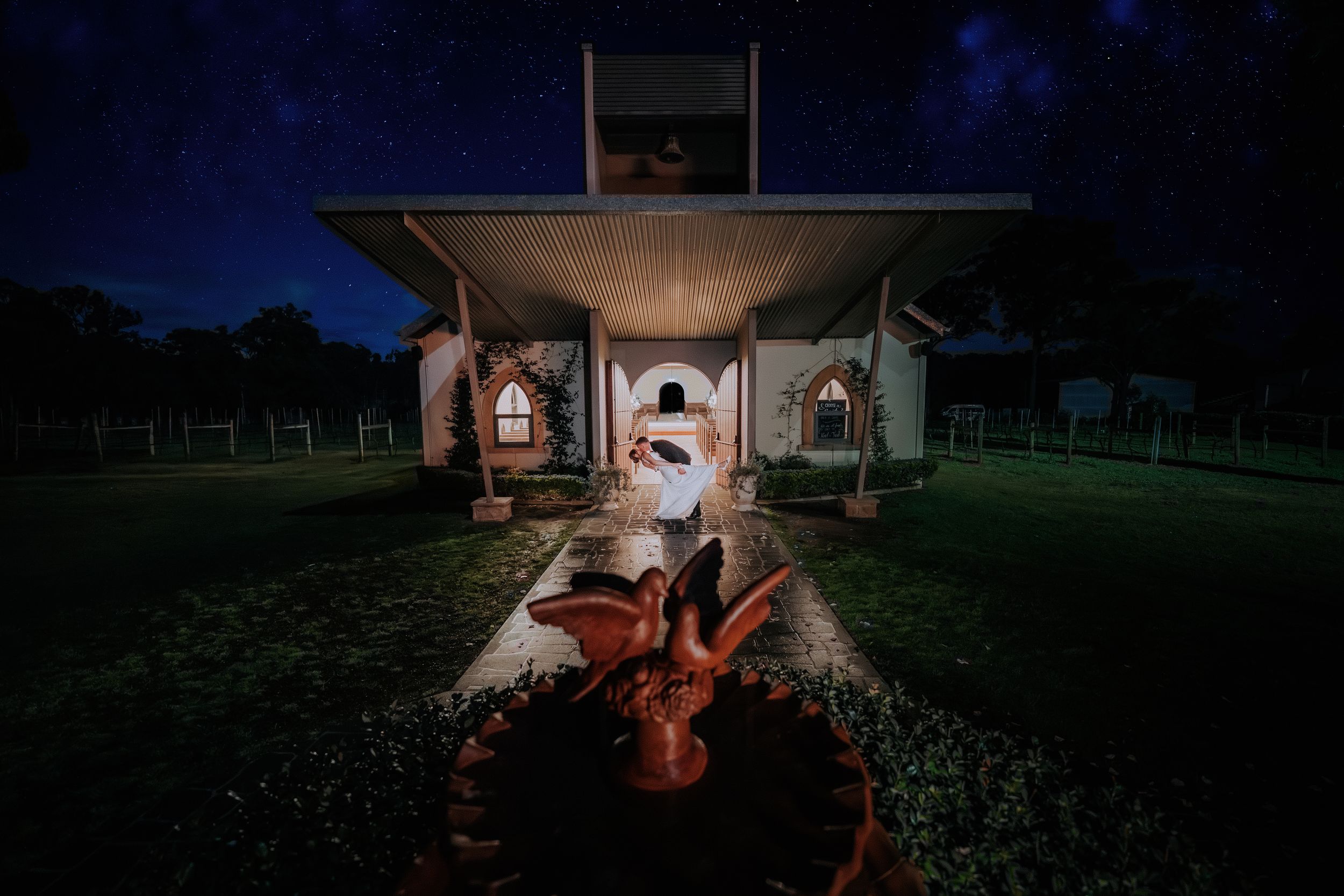 Night photography of rustic barn venue with creative lighting techniques.