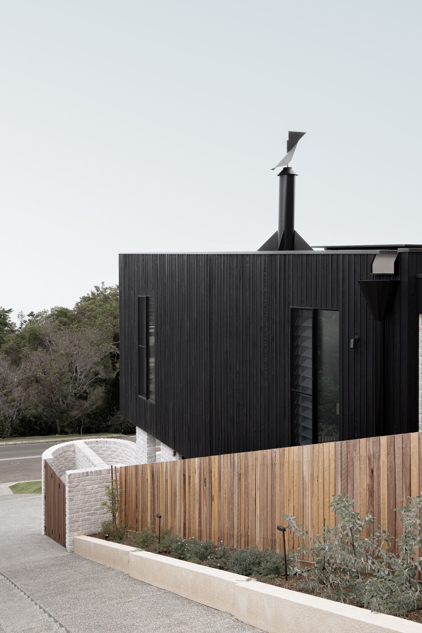 Timber and textured brick facade of Carbon Skins Kiama — editorial photography for architects and builders
