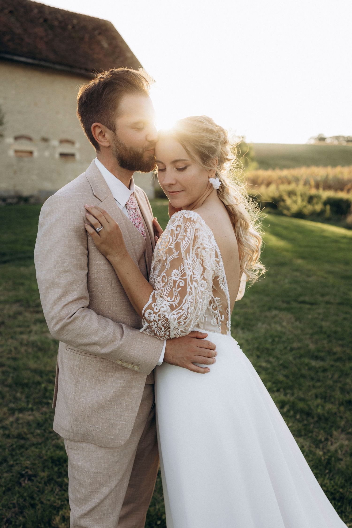 A tender autumn embrace captured during a wedding photoshoot with fall foliage.