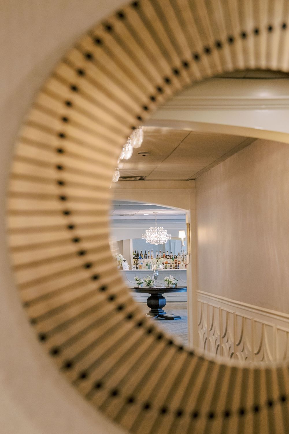 A creative series of mirror reflections showing a coastal harbor view through decorative oval-shaped wooden frames.