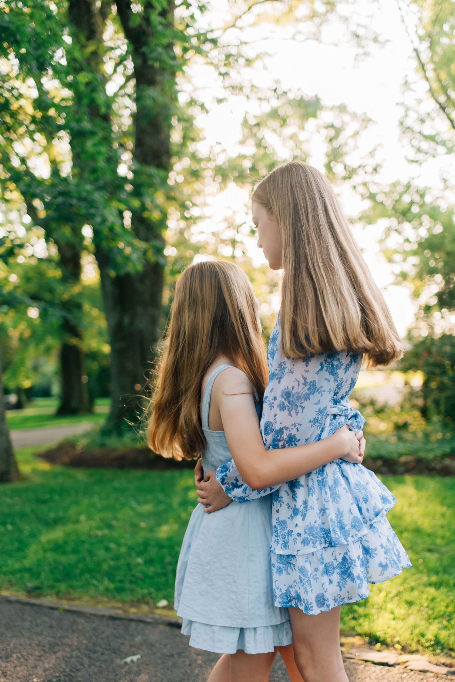 Sisters hugging in golden hour light in Pittsburgh, PA