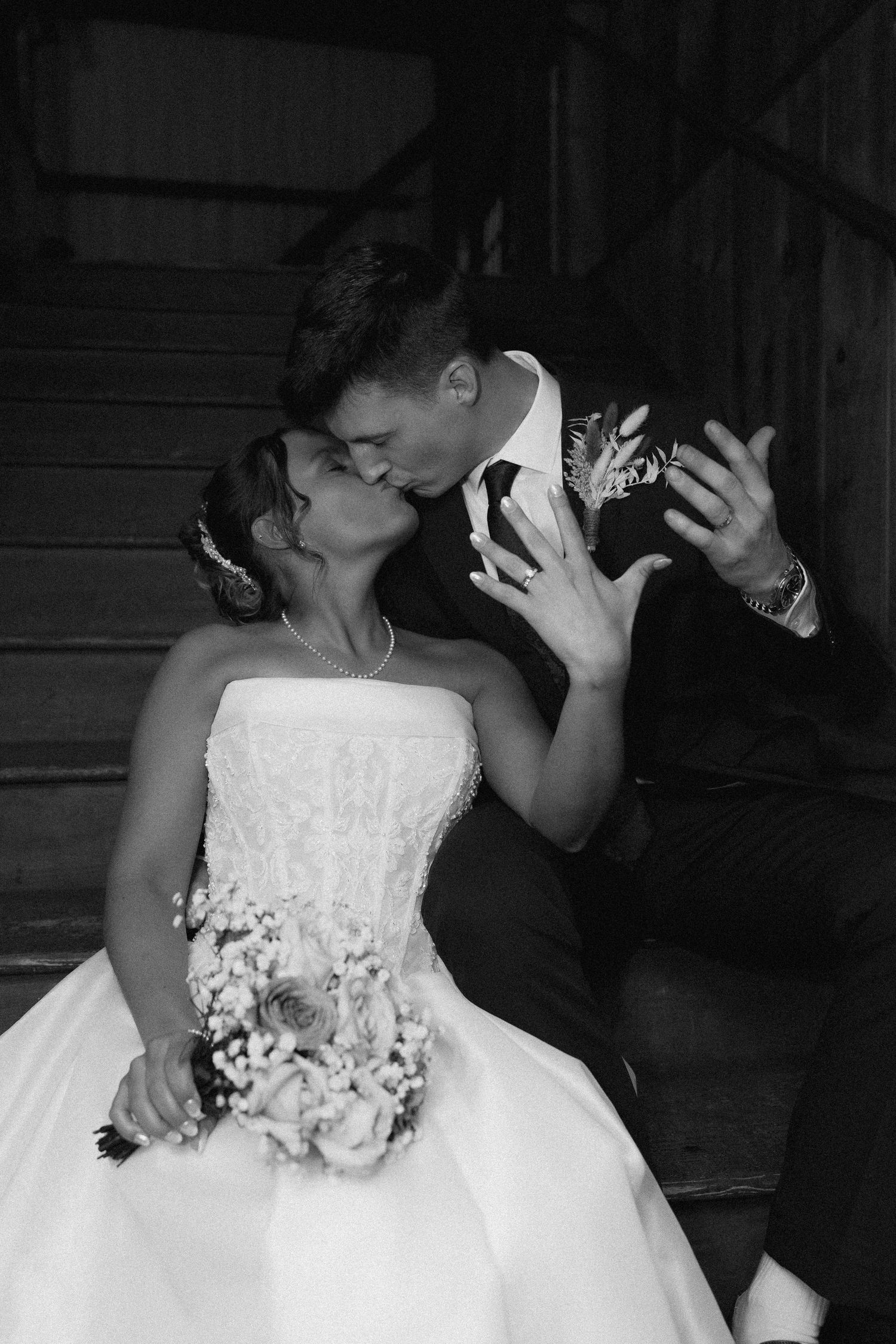 Artistic black and white wedding portrait on lakeside at sunset.