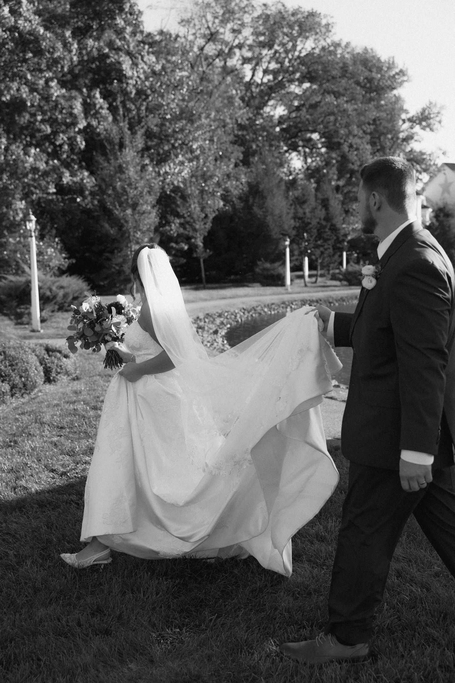 Artistic black and white wedding portrait on lakeside at sunset.