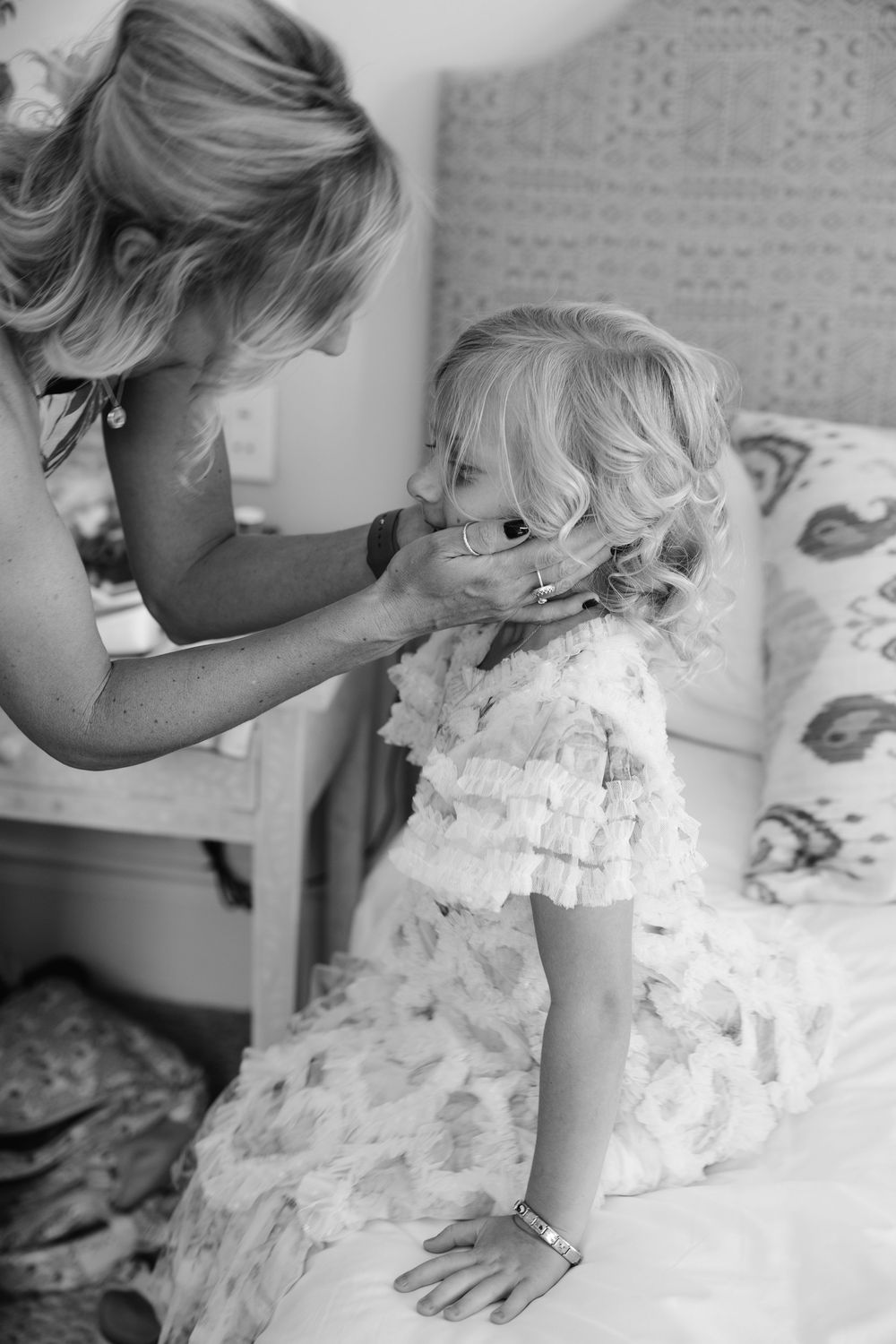 A series of black and white photos showing a child in a white ruffled dress looking down at an open book.